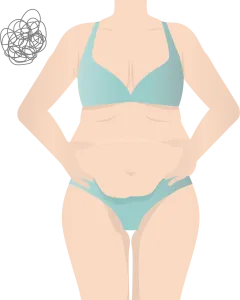 おなかの肉をつまむ肥満体型の女性