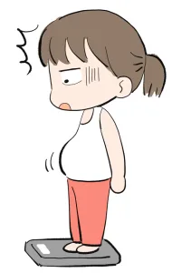 体重計に乗って驚いてる女性
