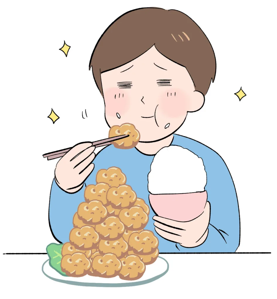 唐揚げとご飯食べる男性